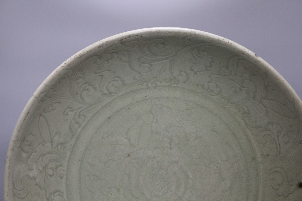 A 15th / 16th century Longquan celadon dish, incised with flowers, diameter 43cm, height 8.5cm